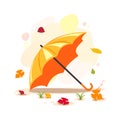 Orange umbrella in fallen leaves