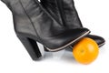 An orange under black leather lady boots Royalty Free Stock Photo