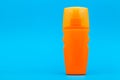 Orange unlable bottle of sunscreen. Royalty Free Stock Photo