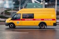 Orange van car of emergency repair service of Mosvodokanal. Ford transit truck driving fast on city street