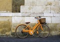 Orange vintage bicycle near old wall Royalty Free Stock Photo