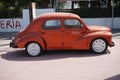 Orange vintage car Renault 4CV. The Renault 4CV is a rear-engined, rear-wheel-drive, 4-door economy supermini manufactured.