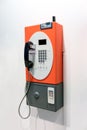 Orange vintage public pay phone Royalty Free Stock Photo