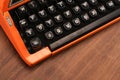 The Orange Vintage Typewriter on the Wood