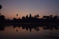 Orange and violet sunrise over famous angkor wat temple with lake and reflection in the water with lillypad Royalty Free Stock Photo