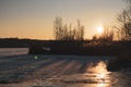 Orange Vivid Sunset On Icy Frozen Reflective Lake