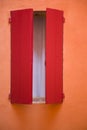 Orange wall, red window shutter Royalty Free Stock Photo