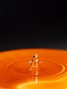 Orange water drop with black background Royalty Free Stock Photo