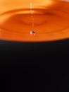 Orange water drop with black background Royalty Free Stock Photo