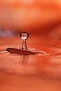 Orange water drop and splash Royalty Free Stock Photo