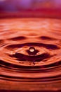 Orange water drop and splash Royalty Free Stock Photo