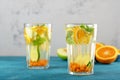 Orange water with sea buckthorn and mint in glasses on blue background Royalty Free Stock Photo