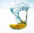 Orange in water, splash and splash, with delicious orange slices Royalty Free Stock Photo