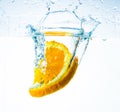 Orange in water, splash and splash, with delicious orange slices Royalty Free Stock Photo
