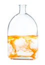 Orange watercolour dissolving in water in flask Royalty Free Stock Photo