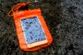 Orange waterproof mobile phone case with water droplets.PVC zip lock bag protect mobile phone or important items from water.