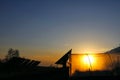 Orange western sun everywhere polyethylene tunnel in the form of a plastic greenhouse against the background of growing vegetables Royalty Free Stock Photo