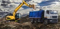An orange wheeled excavator is loading a dump truck at a construction site. Loading a vehicle for transporting soil. Excavator