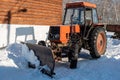 Wheeled snow plow tractor with blade in winter Royalty Free Stock Photo