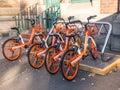 Orange wheels bicycle `Mobike bike sharing` is dockless system uses a smartphone app to unlock bicycles, charging an hourly rate