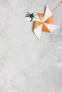 Orange whirligig with white stars and black rubber spider