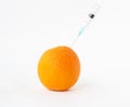 Orange on a white background in which enter gmo and nitrates, close-up, genetically modified organism, orange Royalty Free Stock Photo