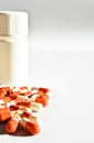 Orange and white capsule pills and white medicine box, isolated on white background Royalty Free Stock Photo