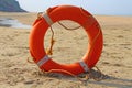 Orange white lifebuoy on the sand