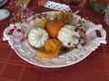 Small pumpkins and gourds of various colors, displayed on platters from various angles and depth Royalty Free Stock Photo