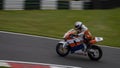 A orange/white racing bike speeding uphill