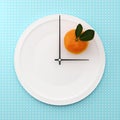 Orange on white round plate in a form of clock on point pattern Royalty Free Stock Photo