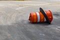 Orange and white traffic barrel knocked over on its side, traffic accident reckless driving Royalty Free Stock Photo