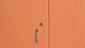 An orange wooden door background with a rusted iron handle Italy, Europe Royalty Free Stock Photo