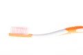 Orange worn toothbrush on isolated white background