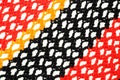 Orange, yellow and black knitted fabric. Eyelet / lace mesh stitch. Knitting pattern macro texture background Royalty Free Stock Photo