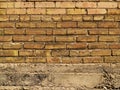 Orange and yellow brick wall over concrete Royalty Free Stock Photo