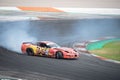 Orange yellow Chevrolet Corvette C5 producing smoke on a trail for a drift competition