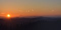 Summer sunset on the horizon across Canadian mountains