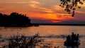 Summer sunset on the horizon across Minnesota lake