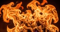 Orange and yellow flames dance against a dark background, creating dynamic, Royalty Free Stock Photo