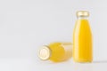 Orange yellow juices in glass bottles with gold empty cap for label mock up on white background with copy space, template for pack Royalty Free Stock Photo