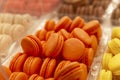 Orange and yellow macaron cake on the counter. Appetizing popular dessert. Close-up