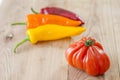 orange, yellow and red bell pepper and costoluto genovese tomato Royalty Free Stock Photo