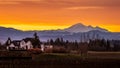 Orange and Yellow Sky at Sunrise over Mount Baker viewed from the Fraser Valley in British Columbia, Canada Royalty Free Stock Photo