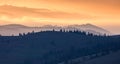 Orange and yellow sunset with mountains silhouettes. Gradient vivid nature background