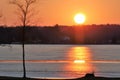 Orange and yellow sunset over frozen lake Royalty Free Stock Photo