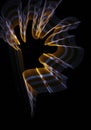 Orange-yellow-white curled line - ribbon painted by light on the black background.