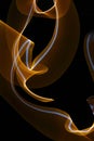 Orange-yellow-white curled line - ribbon painted by light. Improvisational painting by light. Royalty Free Stock Photo