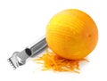 Orange zest, zester tool and fruit isolated on white Royalty Free Stock Photo