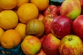 Oranges and apples close up. Fruit stall at the farmers market. Bright ripe fruits of plants are laid out for sale Royalty Free Stock Photo